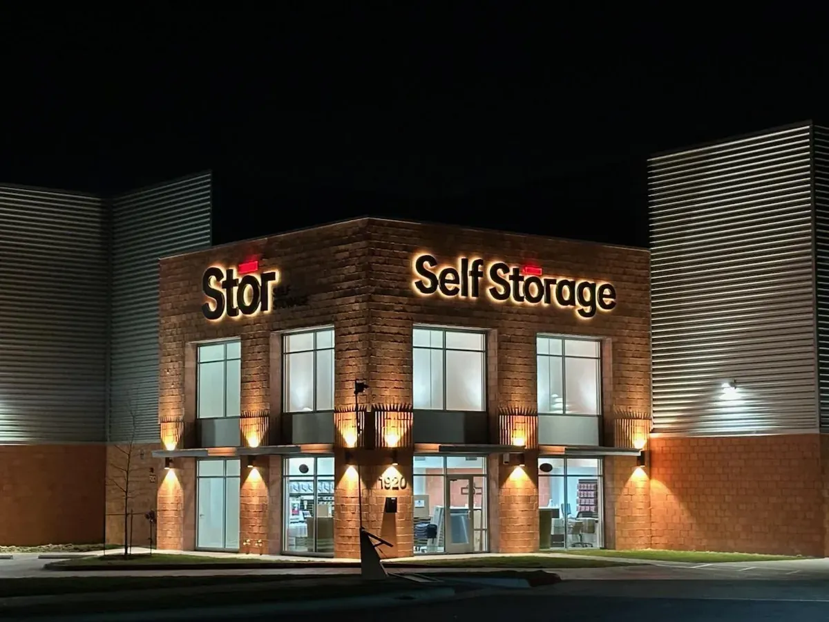 Well lit entrance to Stor Self Storage at night